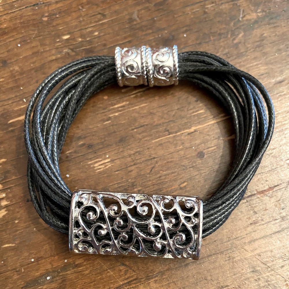 Silver tone filigree and leather bracelet